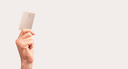 Banner with hand holding credit card mockup with chip. Contactless transactions, secure payments concept. Place for text. High quality photo