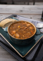 Traditional German lentil soup with a piece of bread