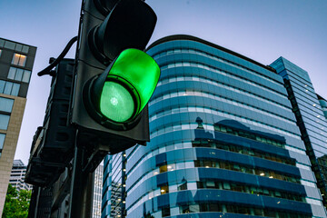 A green traffic light on the street at dawn - Powered by Adobe