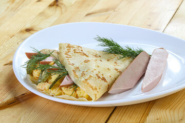 Pancake with potato and sausages
