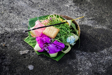 Beautiful balinese offering with a stick of incense