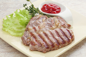 Grilled pork neck steak with ketchup