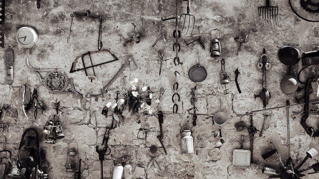 Antiquary Stuff on the Wall. Used Tools. Obsolete Things. Black and White Photo