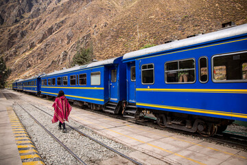 Obraz premium woman by train to get to Aguas Calientes and climb to Machupichu, the Inca ruins in Peru