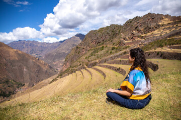 Woman on farming terraces at Inca ruins at Pisac in the Sacred Valley in Cusco, Peru