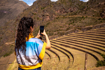 Woman on farming terraces at Inca ruins at Pisac in the Sacred Valley in Cusco, Peru - obrazy, fototapety, plakaty