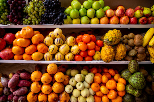 different organic fruits put in a market, custard apple, banana, pear, pomegranate and tangerines