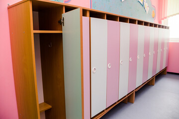 Pink and white  doors of children wardrobes for clothes in the kindergarten
