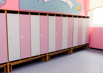 Pink and white  doors of children wardrobes for clothes in the kindergarten