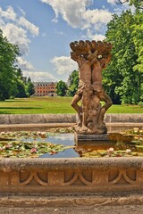 Obraz premium A fountain decorated with sculptures at Sychrov Castle in the Czech Republic.