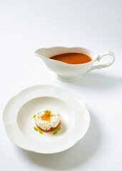 gazpacho with tomato dressing in a plate on a white background