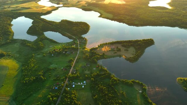 Lake in rural, aerial view. Freshwater Lakes. Abandoned Trinity Church in village of Belaya Tserkov. Lake Chereiskoye in Chereya village. Lighthouse on island. Panoramic landscape view of river.