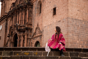 Fototapeta na wymiar Tourist woman looking at cusco cathedral in plaza mayor, Peru