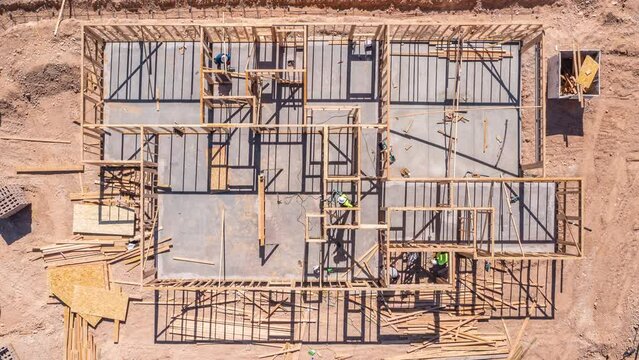 Aerial tripod shot of construction workers building wooden home in Las Vegas