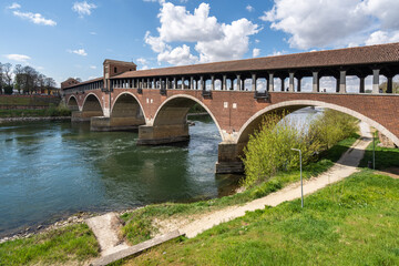 Fototapeta na wymiar The Ponte Coperto (Covered Bridge) in Pavia, a brick arch bridge over the Ticino River, Lombardy, Italy