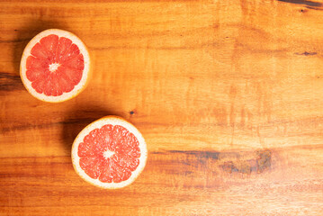Fototapeta na wymiar Grapefruit, halved grapefruit on a rustic wooden surface, Top view.