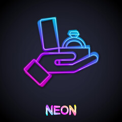 Fototapeta premium Glowing neon line Diamond engagement ring in a box icon isolated on black background. Vector