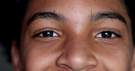 Child closing eyes taking a deep breath and smiling at camera. Macro close-up kid face opening eye