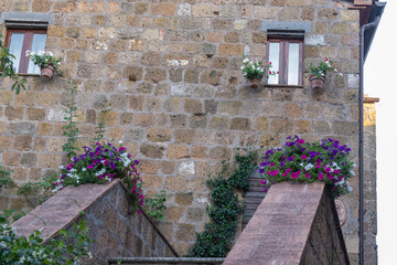 Exterior shot of spectacular ancient buildings of stones with cobblestone courtyard in the...