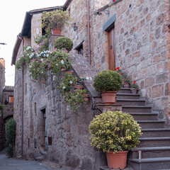 Exterior shot of spectacular ancient buildings of stones with cobblestone courtyard in the...