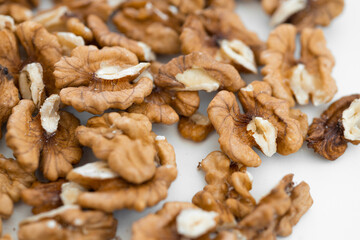 Half peeled walnut closeup isolated on white background