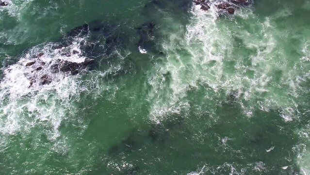 Aerial top view 4k footage by drone of ocean waves in slow motion. Danger sea waves on a beach