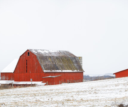Red barn on a snowy white hill in Amish country, Ohio