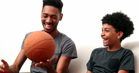 Brothers bonding together with basketball. Mixed race, black ethnicity siblings playing and spinning ball