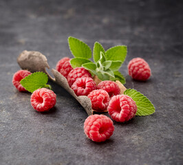 Ripe Raspberries with fresh mint leaves Isolated on black background