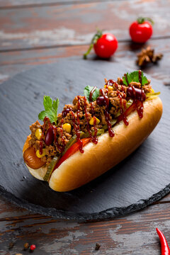 hot dog Mexican with jalapeno, corn and meat, chili con carne macro close up vertical