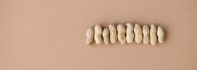 Shelled peanuts on brown background