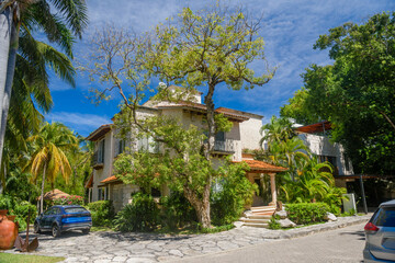 Fototapeta na wymiar Luxury authentic historical villa in shadow of trees in Playa del Carmen, Yukatan, Mexico