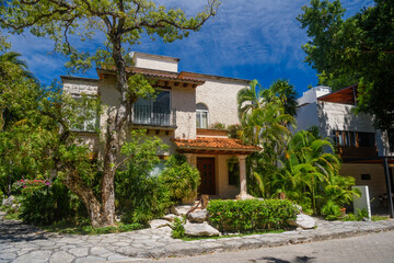 Fototapeta na wymiar Luxury authentic historical villa in shadow of trees in Playa del Carmen, Yukatan, Mexico