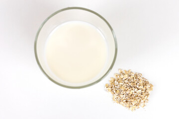 Vegan oat milk, non dairy alternative milk in a glass close up.