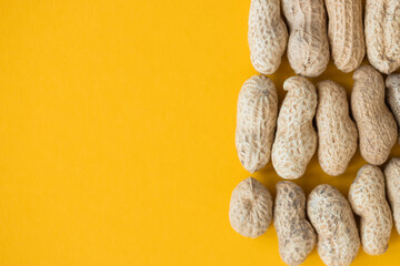 Shelled peanuts on yellow background