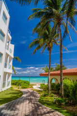 Fototapeta na wymiar Luxury white villa with palms in Playa del Carmen, Yukatan, Mexico