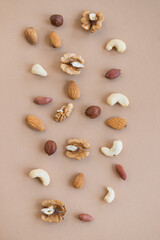 Fototapeta na wymiar nuts mix for a healthy diet cashew, peanut, hazelnuts, walnuts, almonds on brown background