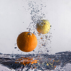 Orange and lemon float in water between the bubbles.

Citrus fruits float in the water between the bubbles. - obrazy, fototapety, plakaty