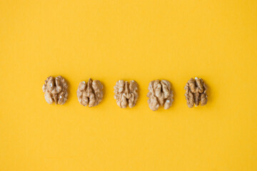 Obraz na płótnie Canvas walnut, nut, isolated on yellow background
