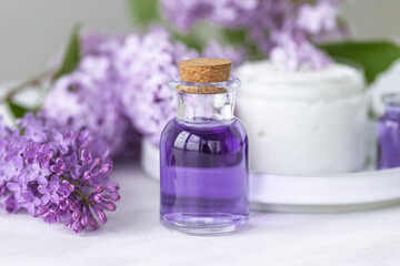 Fototapeta na wymiar Concept of pure natural organic plant-based ingredients in cosmetology, herbal and flower extract. Lilac for anti-age and anti-acne therapy, gentle face and body skin care