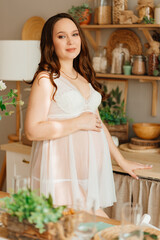 a pregnant woman in white peignoir. beautiful and sexy clothes for pregnant. 