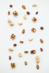 Pattern of nuts mix. Cashew, peanut, hazelnuts, walnuts, almonds on white background