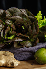 Bunch of fresh lettuce leaves on a dark background. Close-up.