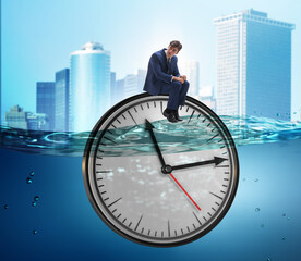 Businessman in deadline and time management concept