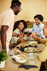 The best friends in the restaurant are making a toast with red wine. Celebration concept.