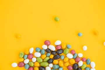 Colorful Chocolate Candy Pills Isolated on yellow Background