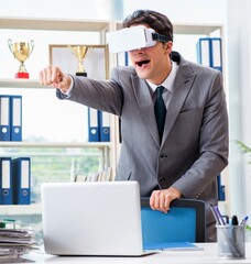 Businessman with VR virtual reality glasses in office