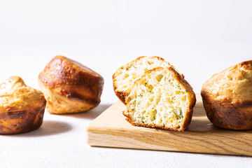 Tasty homemade muffins with dill, spices and cheese on the wooden tray on white background close up. Healthy tasty food concept.