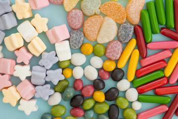 many different candies, sweets on blue background