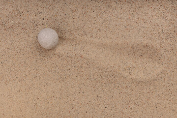 Fototapeta na wymiar Stone and white on golden sand view top zen concept. Copy-space.